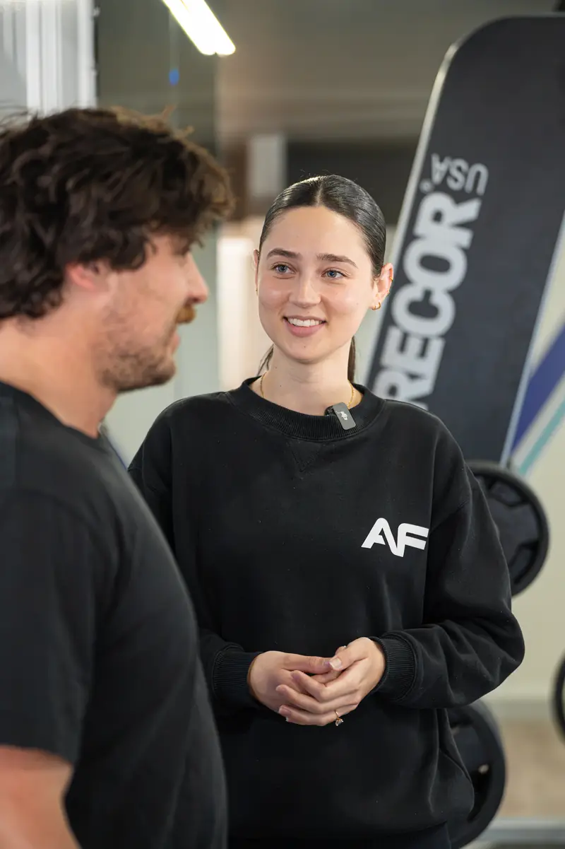 Bria chatting with Michael on the gym floor